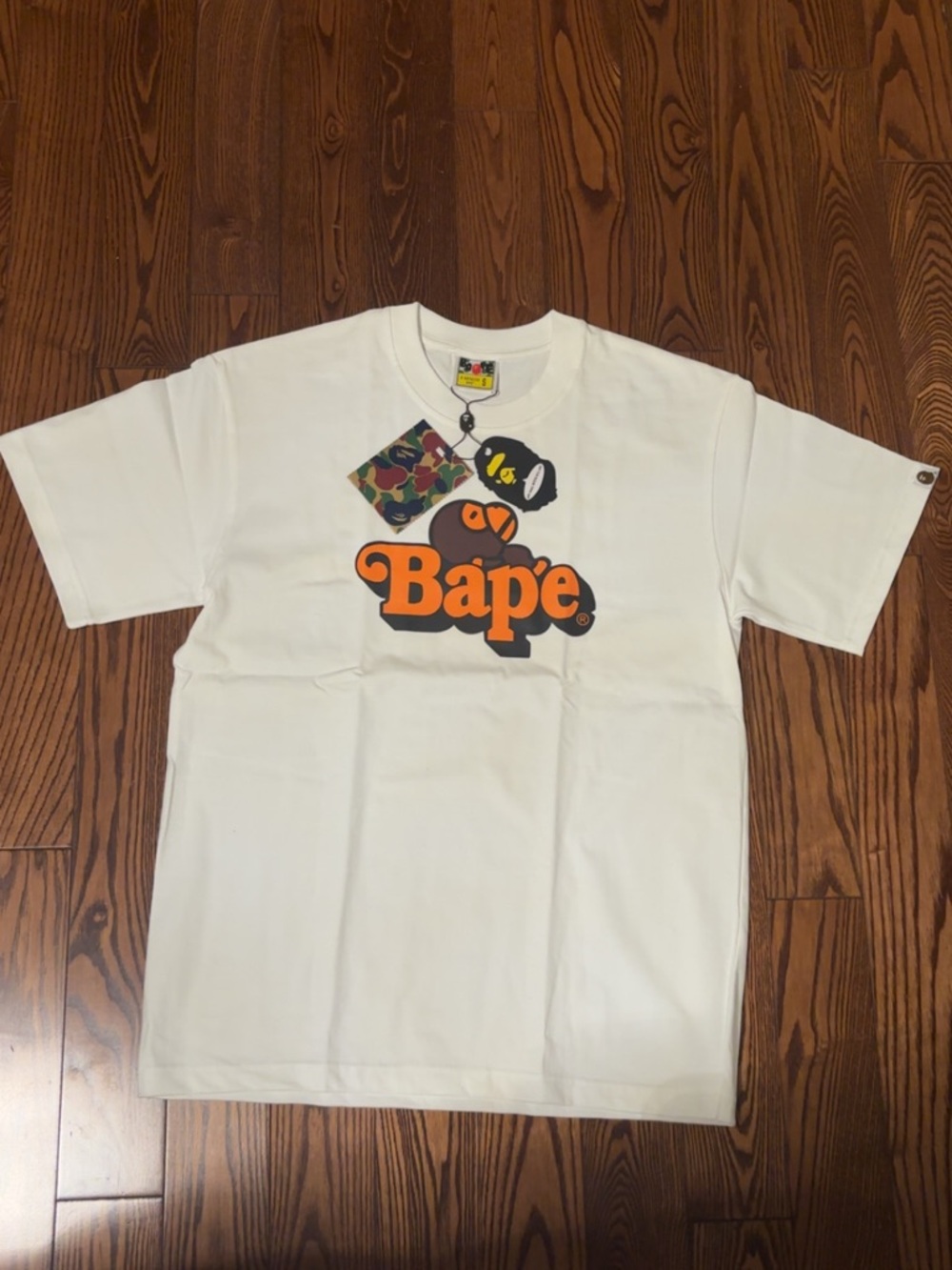 Bape White Tee with Orange Logo and Camo Tag Graphic
